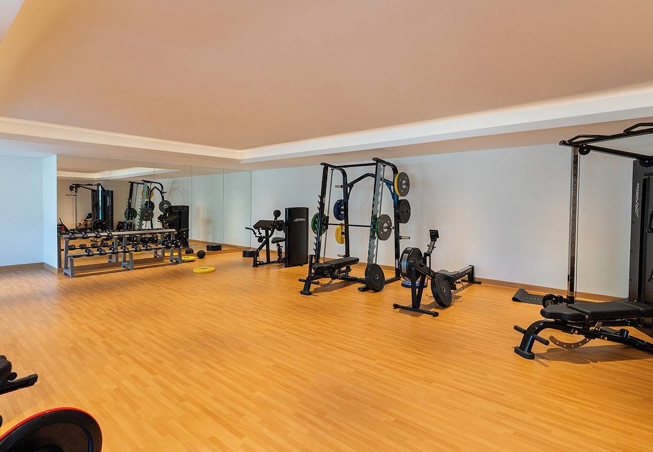A gym with various exercise equipment, including weight machines and free weights.