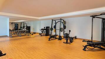 A gym with various exercise equipment, including weight machines and free weights.