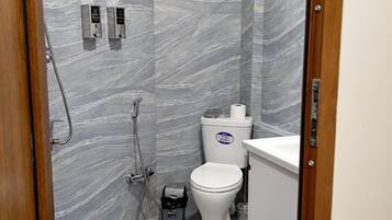 A bathroom with a shower, toilet, and sink.