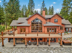 A two-story wooden house with a deck, large windows, and a chimney. - West Cobb- Private- sleeps 16- hot tub- petsOK (McCall)