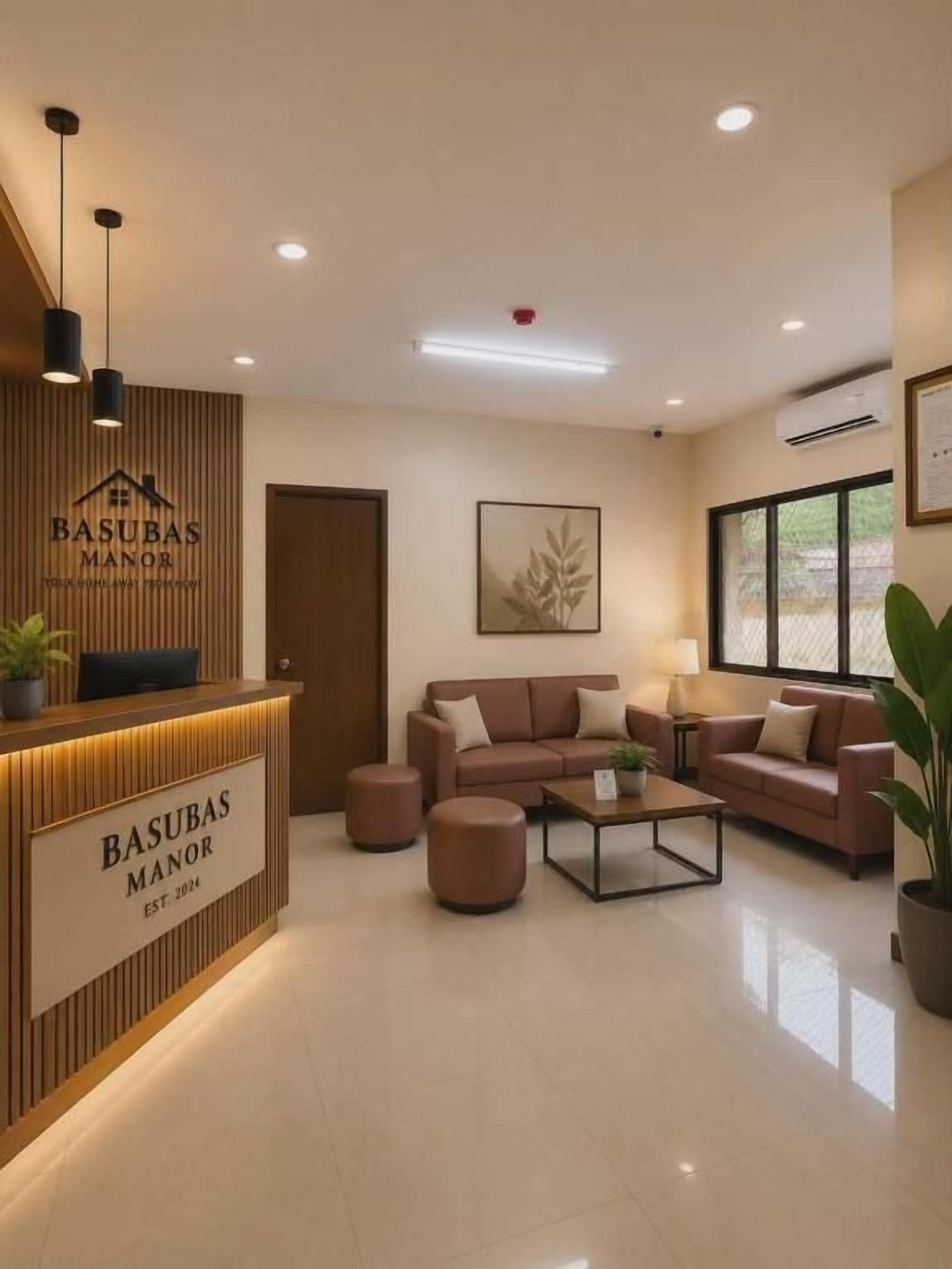 A reception area with a wooden desk, a sofa, and a coffee table.