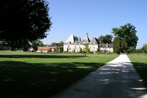 A large, historic building with multiple towers and a central courtyard. - Holiday home in Lusignac with swimming pool (Lusignac)