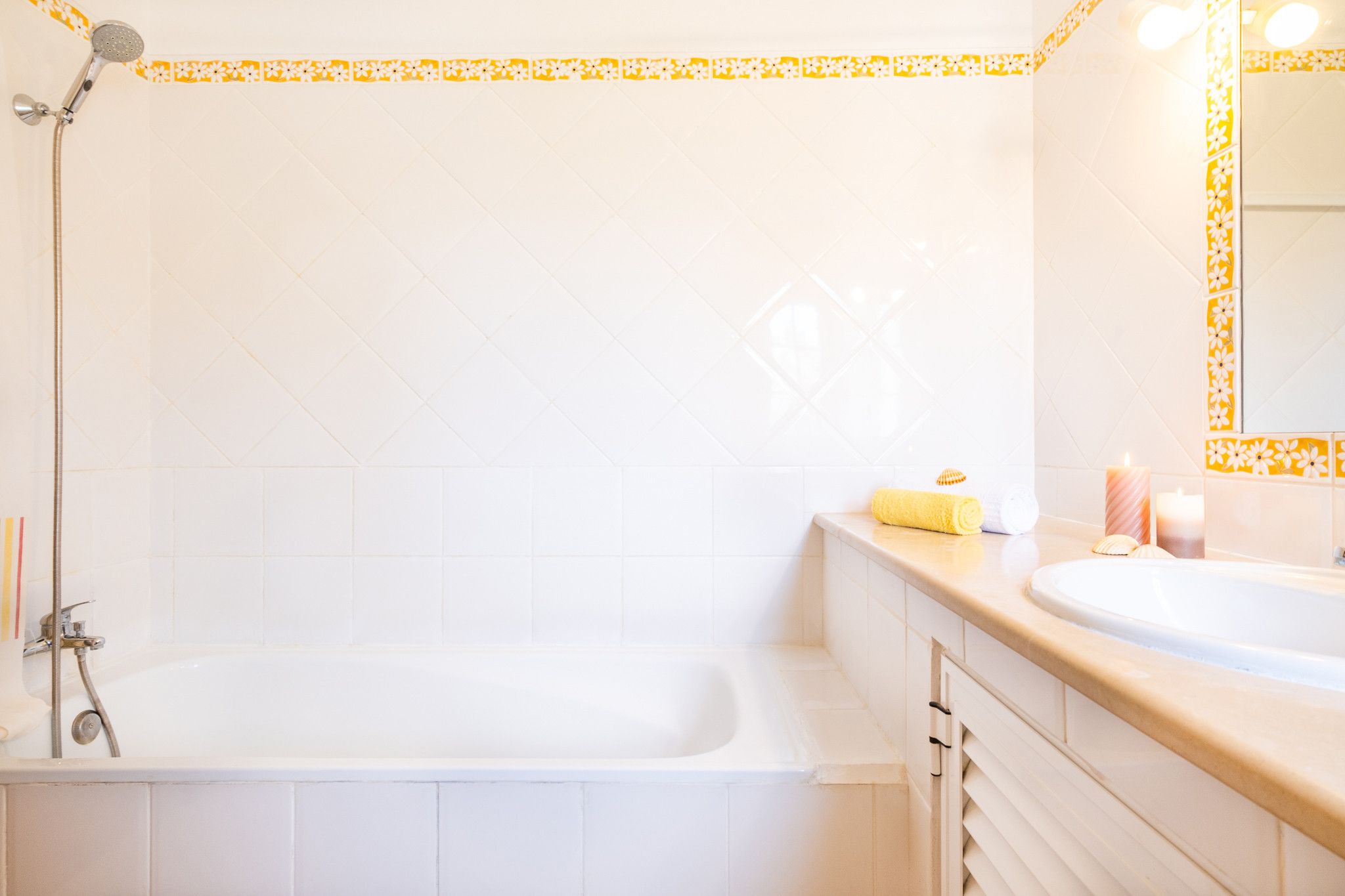 A bathroom with a bathtub, a shower, a sink, and a mirror.