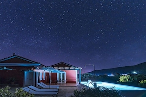 A house with a covered outdoor area, a pool, and a starry night sky. - Villa on Samos Island with swimming pool (Samos Island)