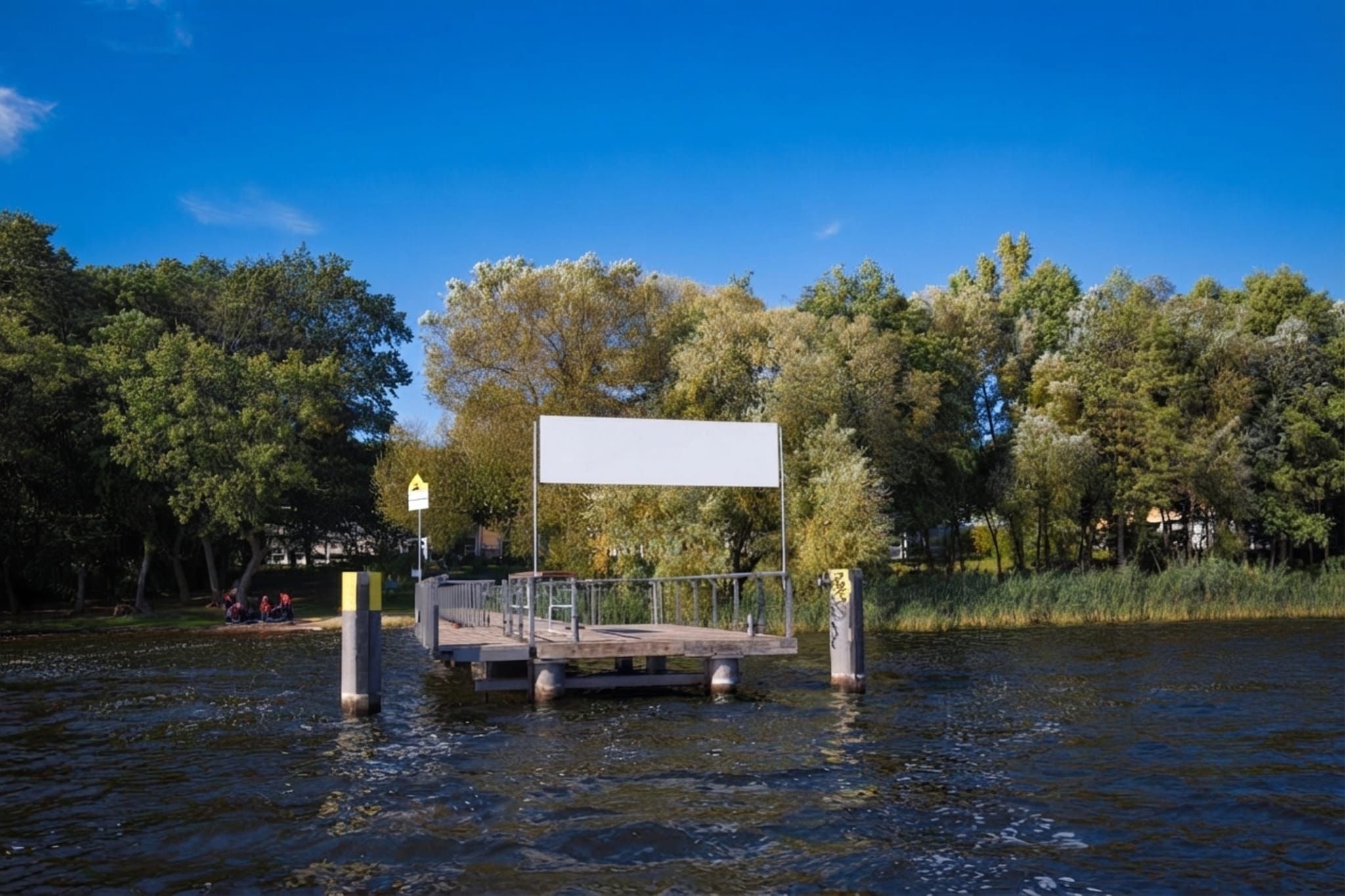 A wooden dock extending into a body of water with a blank signboard on top.