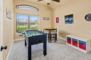 A room with a foosball table, a Play Room sign, a Mustang logo, and a window with a view of greenery. - 15m to Dyess AFB - 3BR, Fenced Yard (Abilene)