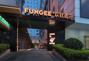 A hotel entrance with a prominent sign reading 'FUNGEE' and a neon sign indicating a restaurant. - FUNGEE X Hotel - Shenzhen Huaqiangbei (Shenzhen)
