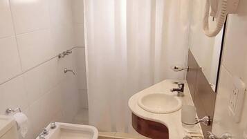 Een badkamer met toilet, wastafel en bidet.