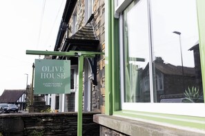 A sign for 'Olive House' indicating luxury rooms and family suites. - Family Suite with Bunk Room | Olive House (Ambleside)