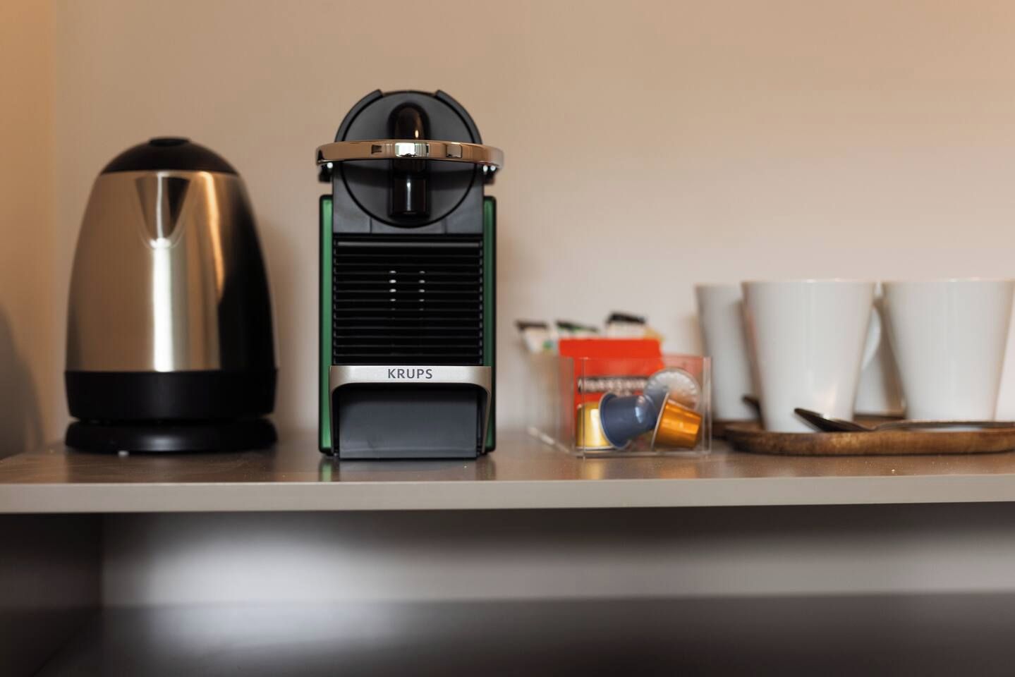 A coffee maker and a Krups electric kettle on a countertop.
