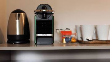 A coffee maker and a Krups electric kettle on a countertop.
