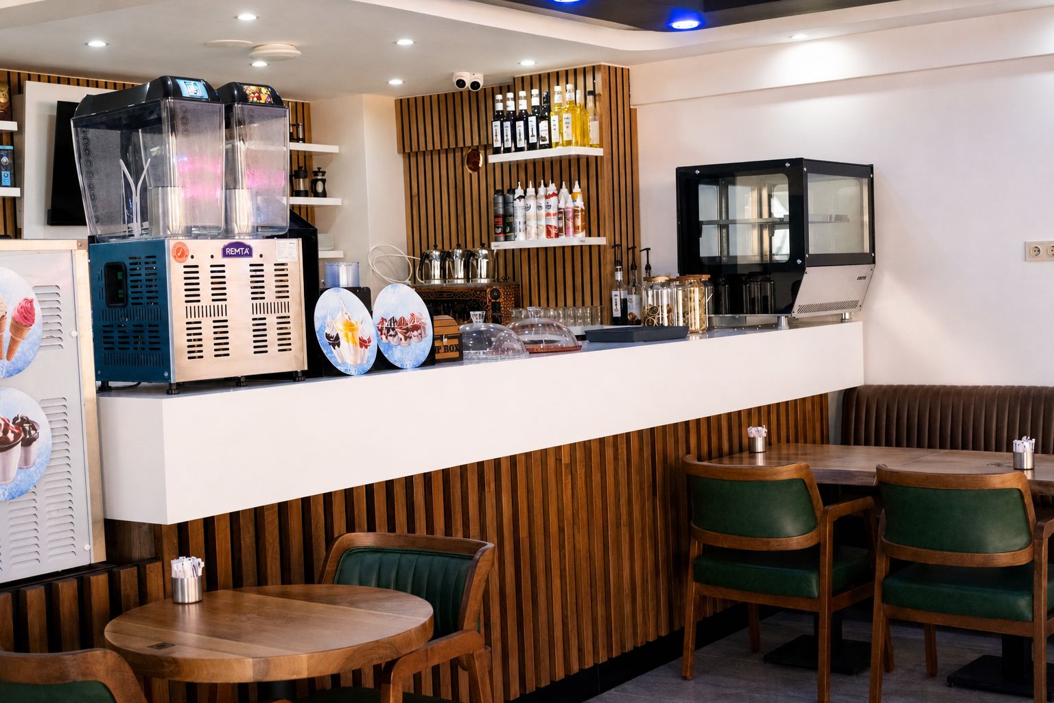 A restaurant interior with a bar area, seating, and a counter with various items.