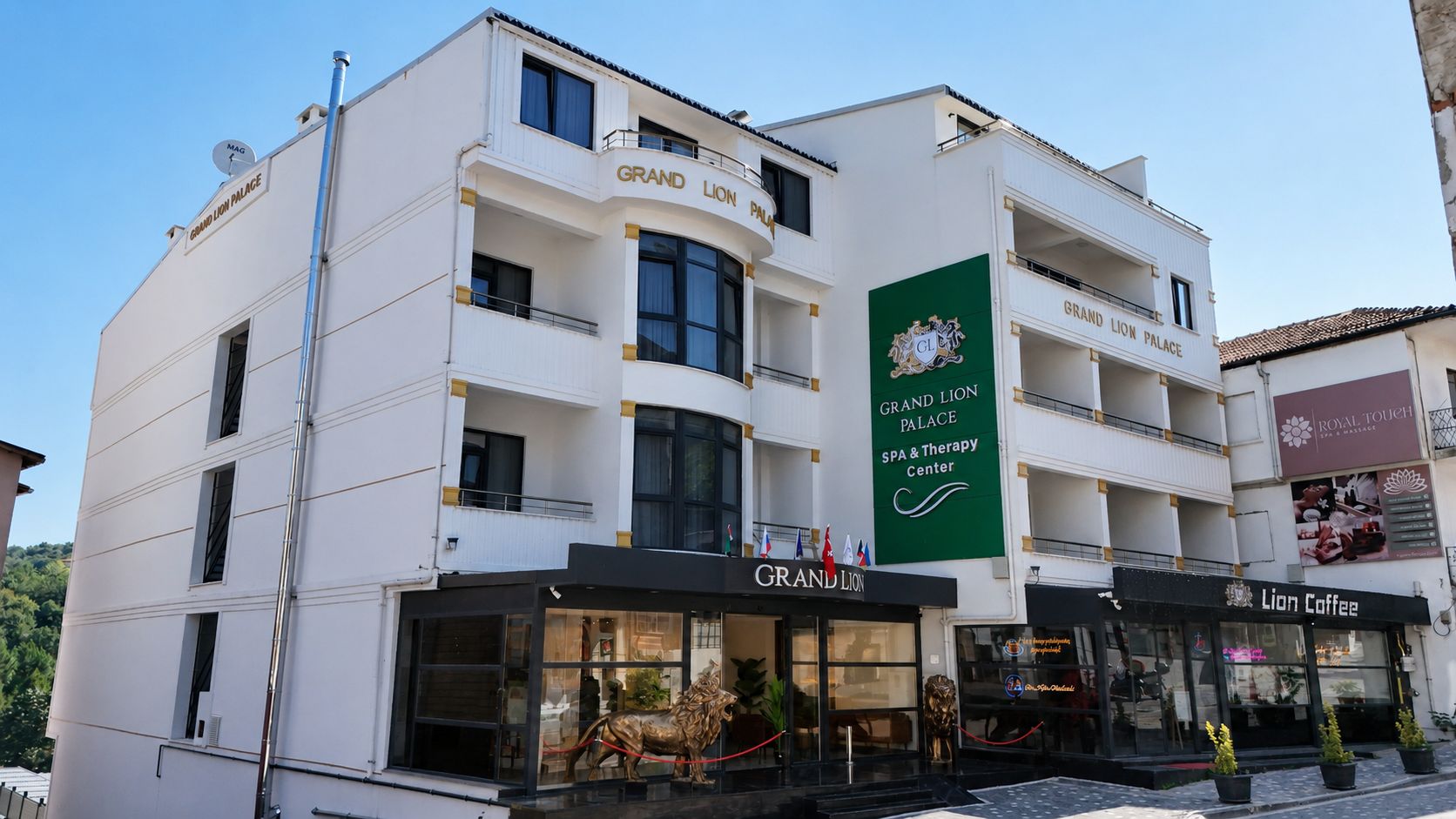 A multi-story building with the signage 'Grand Lion Palace' and 'Spa & Therapy Center' on the facade.