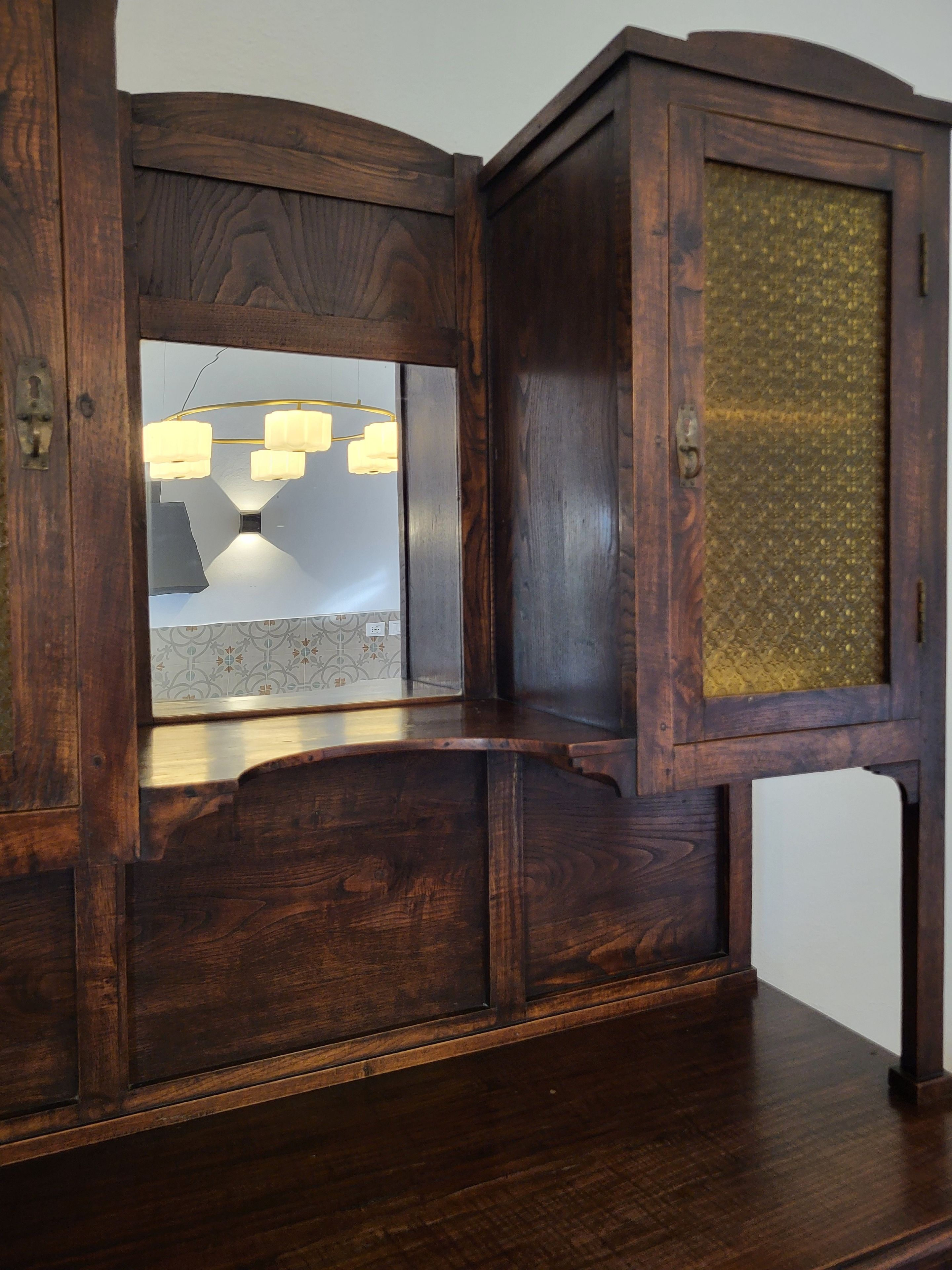 A wooden cabinet with a glass door and a built-in light fixture.