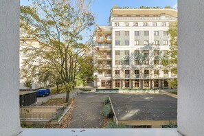 A multi-story residential building with a parking area in front. - Lumina 2BR Apart near Center of Warsaw (Warszawa)