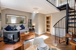 A modern living room with a sofa, coffee table, and dining area set. - Glasgow City Centre, Nr Central Station, Private Parking (Glasgow City)
