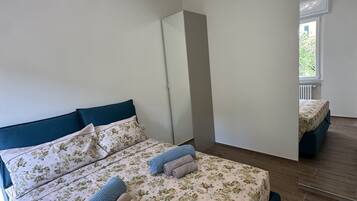 Une chambre à coucher avec un lit, des oreillers et une fenêtre.