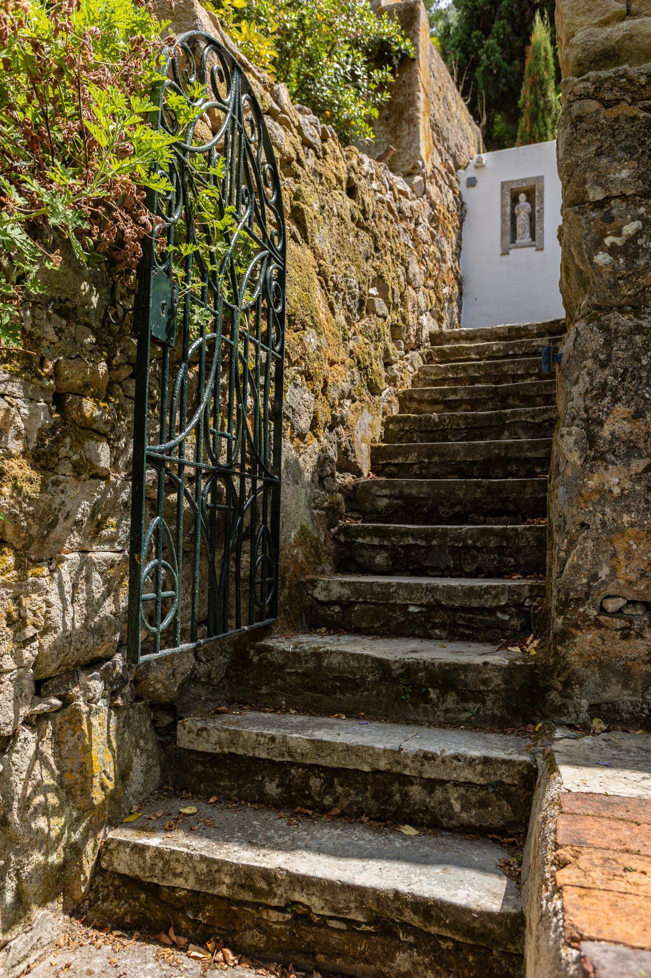 A stone staircase with metal railings leading to a building.