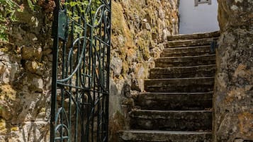 A stone staircase with metal railings leading to a building.