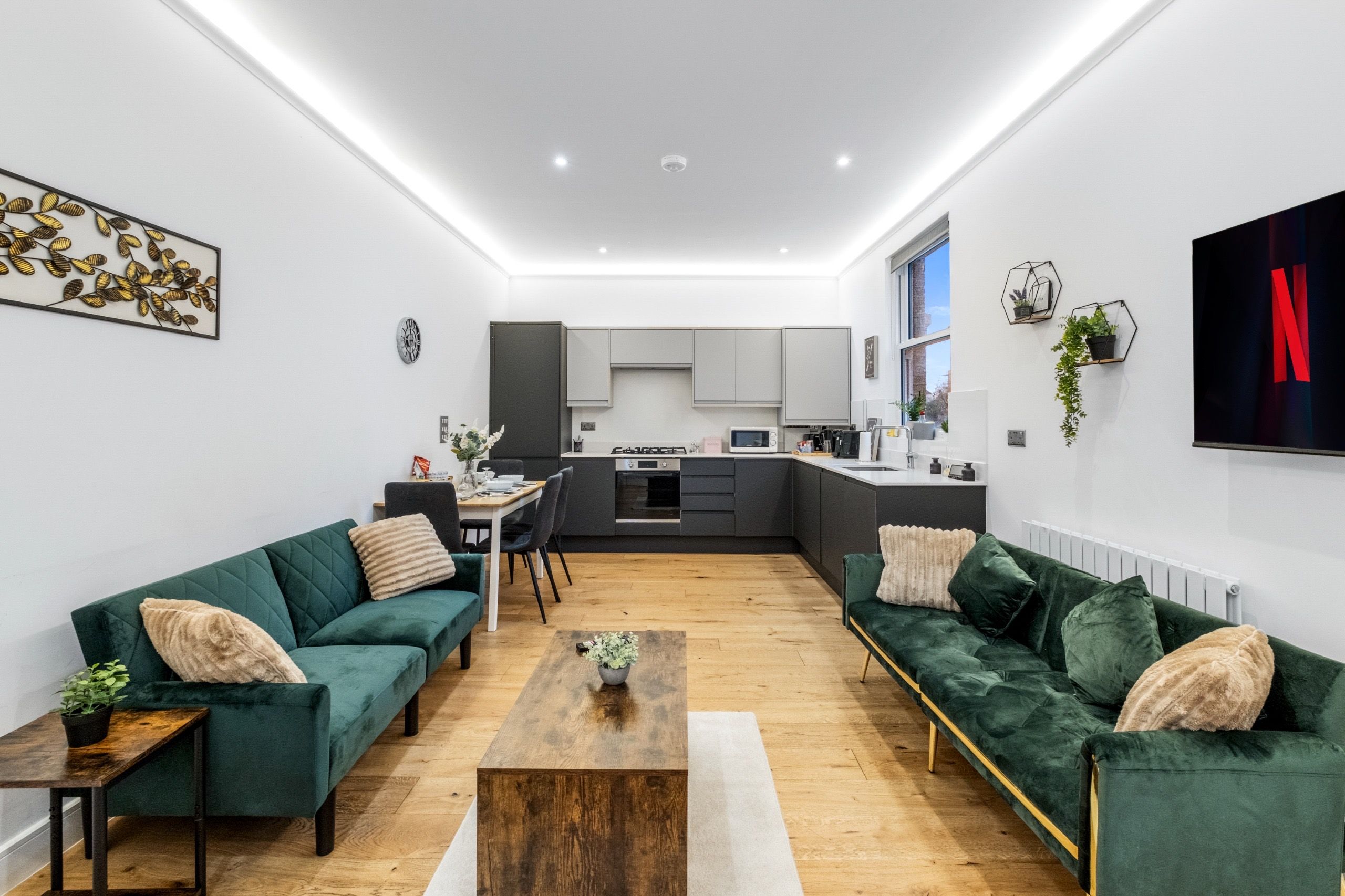 A modern living room with a sofa set, a coffee table, and a dining area with chairs.