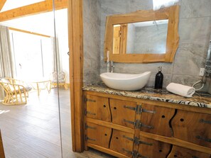 A bathroom with a wooden vanity, marble countertop, and a large mirror. - Large modern farmhouse, surrounded by 40 acres of private countryside (Unknown)