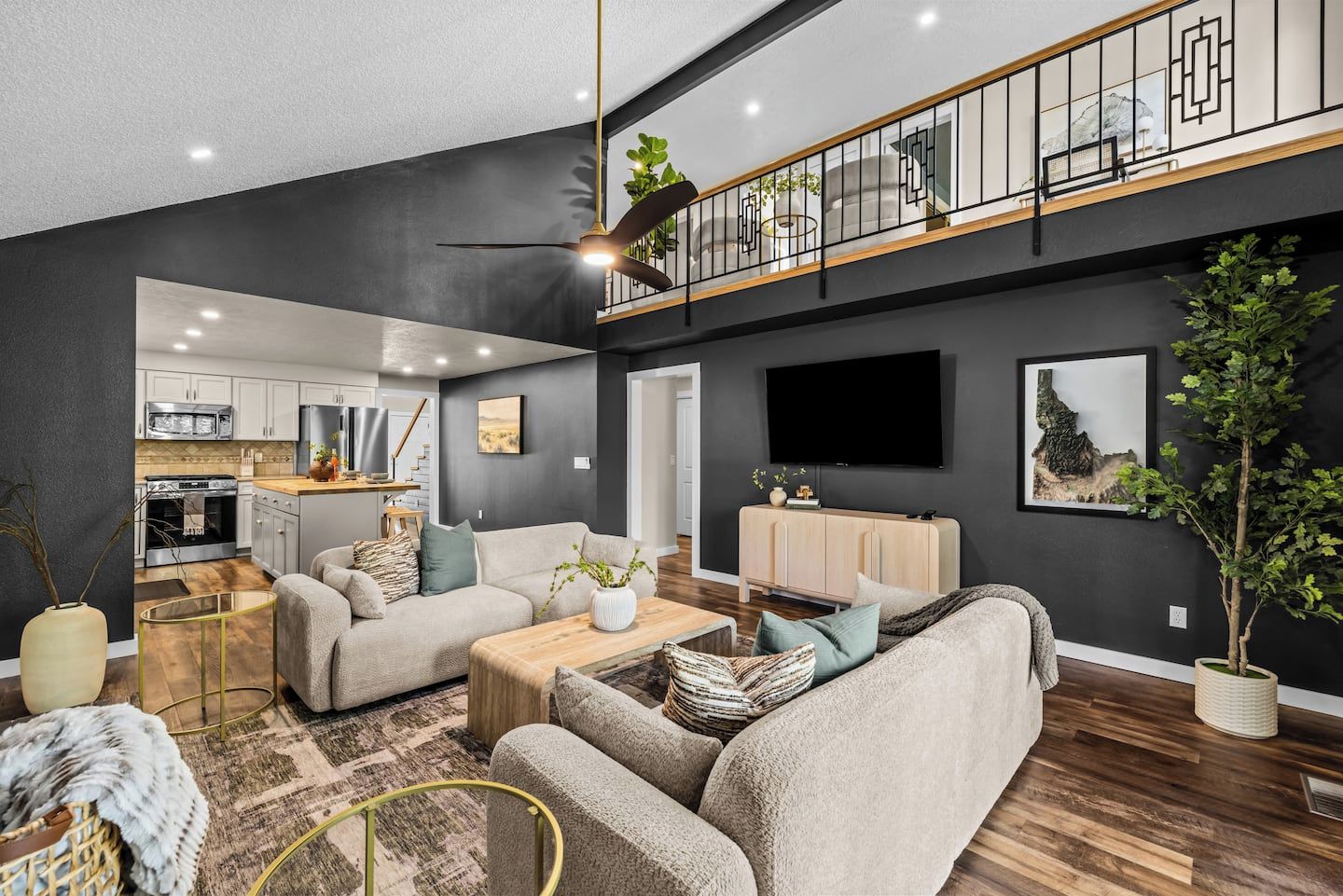 A modern living room with a sofa, coffee table, and a TV mounted on the wall.