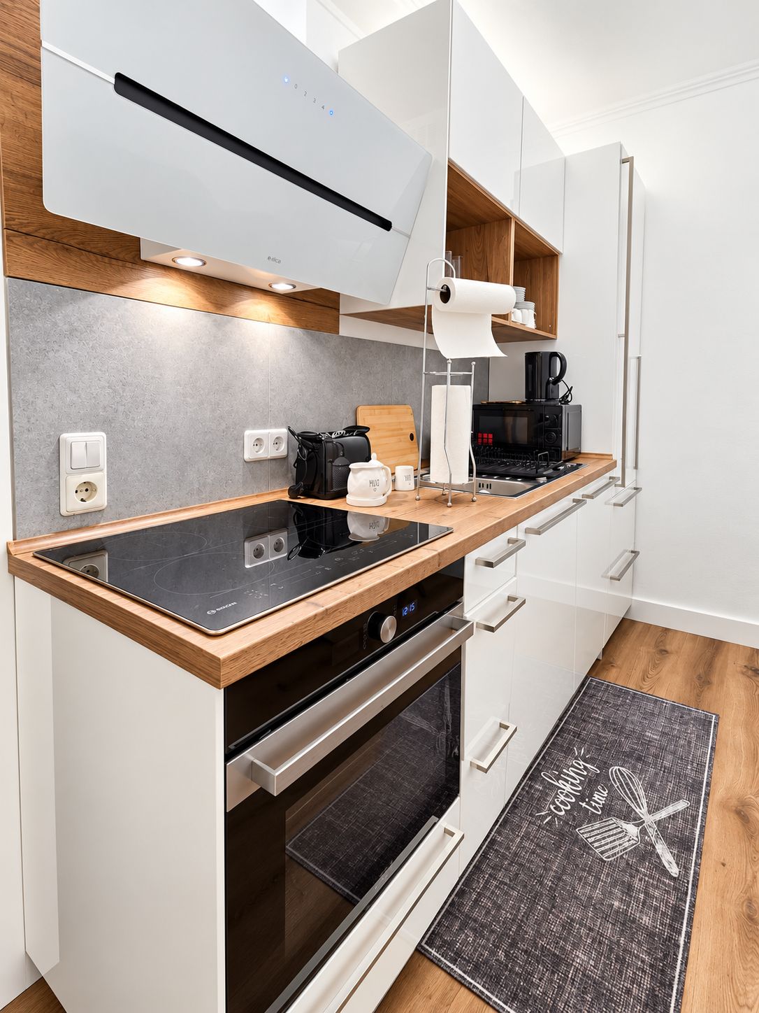 A modern kitchen with a built-in stove, oven, and microwave.