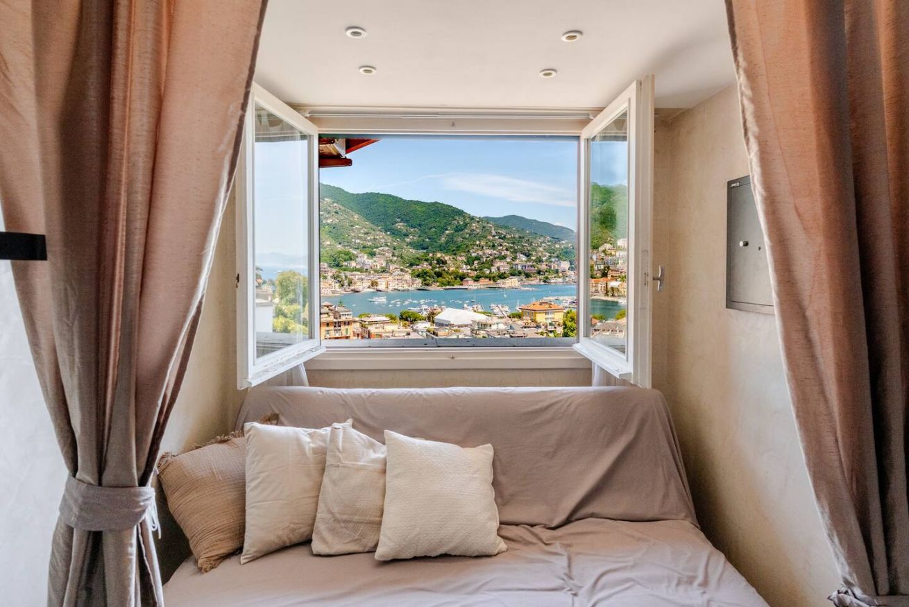 A room with a bed, a window, and curtains.