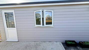 A single-story building with a white door and a window.