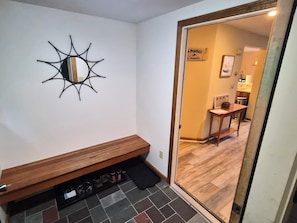A room with a wooden bench, a mirror, and a tiled floor. - Multi-level, spacious, AC/FP, Mtn Views, Deck, Swim Club. F0372 by LRS (Lincoln)