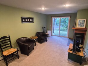 A living room with a fireplace, a sofa, a chair, and a small table. - Multi-level, spacious, AC/FP, Mtn Views, Deck, Swim Club. F0372 by LRS (Lincoln)
