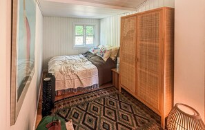A bedroom with a bed, a window, a wardrobe, and a patterned rug. - 2 bedroom lovely home in Nykøbing Sj (Nykøbing Sj)