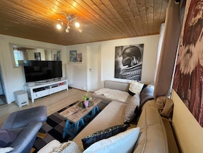 A living room with a television, sofa, and coffee table. - 5 Person Holiday Home in Uddevalla (Uddevalla)