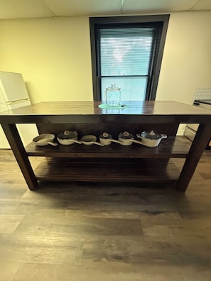 A dining table with a dark finish, a glass jar with a lid, and four white containers with lids on the table. - "The Office" themed house in charming Topeka (Topeka)