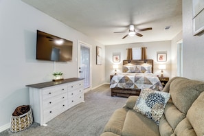 A bedroom with a bed, a dresser, a TV, and a ceiling fan. - Game Room & Private Yard! Family Houston Escape (Houston)