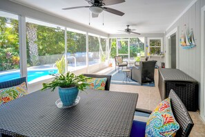 A sunlit patio with a pool, outdoor furniture, and a view of the ocean. - 4 Minute Walk to Private Beach Plus a Private Pool (Vero Beach)