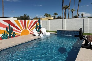 A swimming pool with a mural, lounge chairs, and a small hot tub area. - Walk to Wigwam Resort! Family & Golfers Oasis (Litchfield Park)