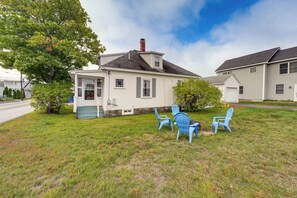 A two-story house with a front porch and a small attached garage. - Steps to Shore! Old Orchard Beach Gem w/ Patio (Old Orchard Beach)