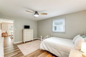 A bedroom with a bed, dresser, ceiling fan, and a window. - Fall Creek in Covington: 2-unit Retreat (Covington)