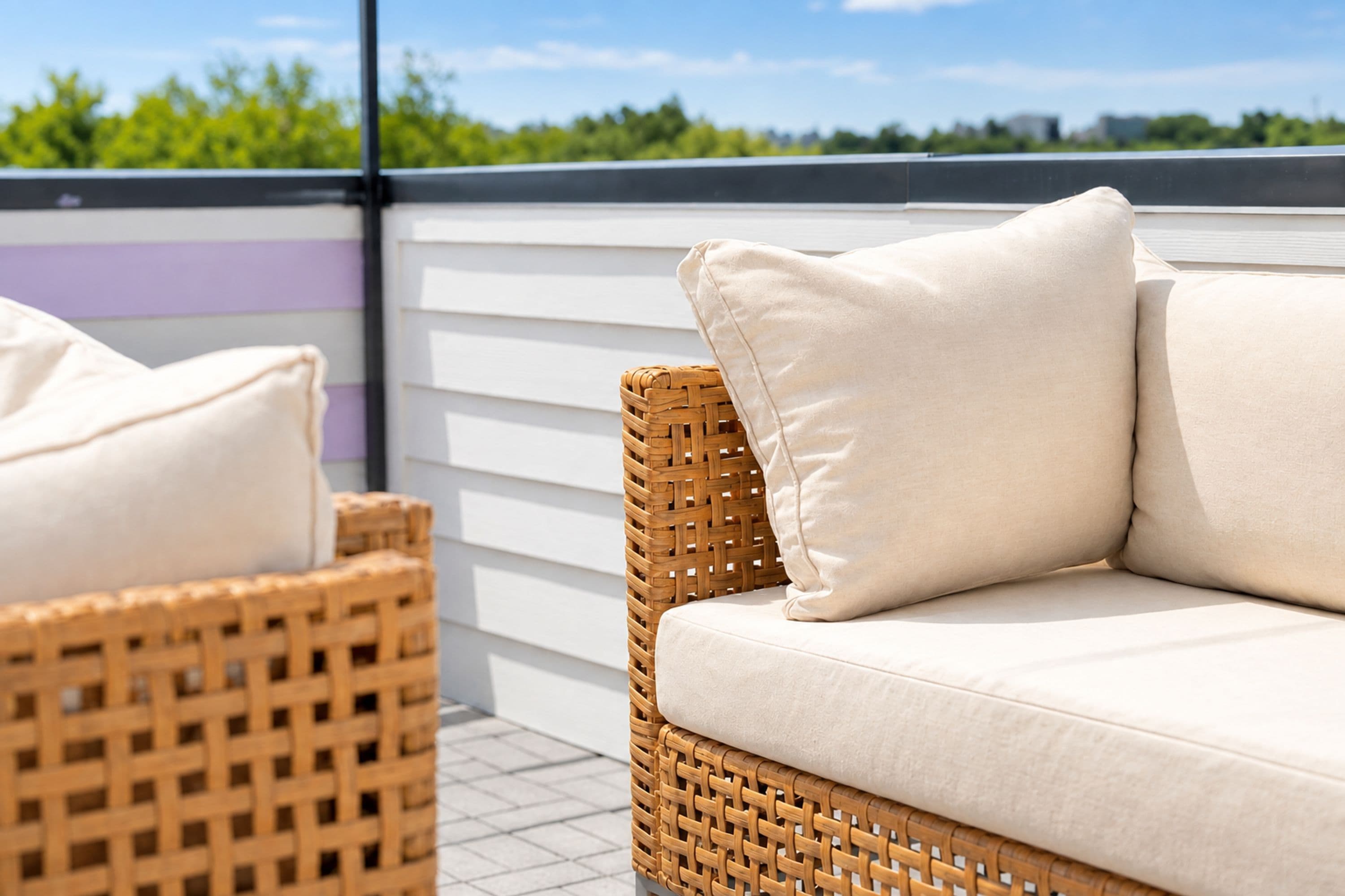 Wicker furniture with cushions on an outdoor patio.