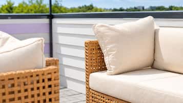 Wicker furniture with cushions on an outdoor patio.