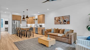 A modern living space with a kitchen, dining area, and seating area.