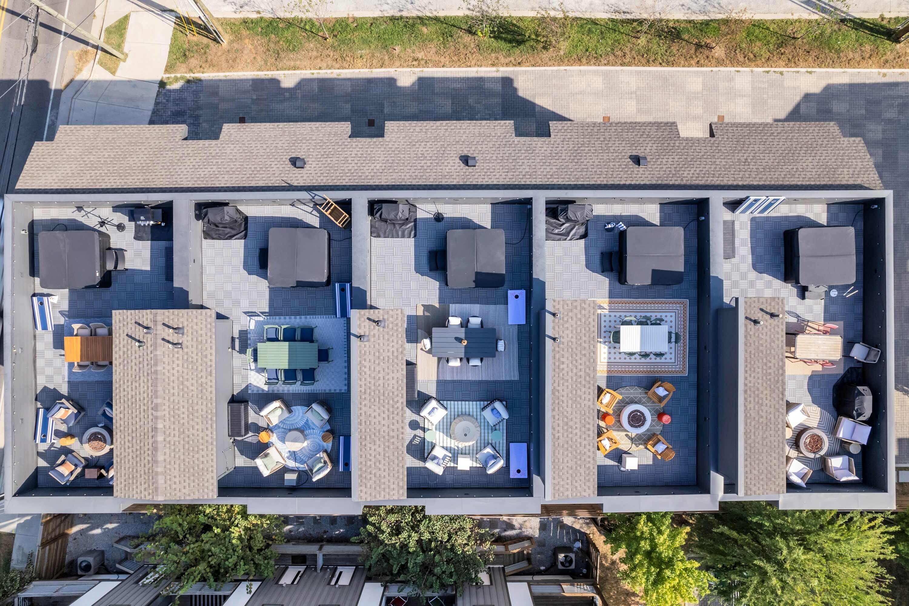 A rooftop terrace with multiple seating areas, a pool, and a dining setup.