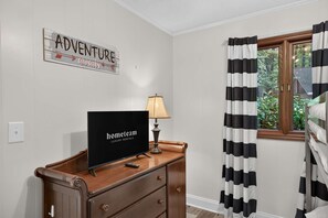 A room with a television on a wooden dresser, a sign on the wall, and a window with curtains. - Lake Norman Haven Private Dock Lake Views (Denver)