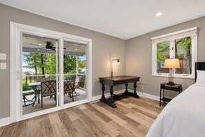 A room with a wooden floor, a table, chairs, a lamp, and a bed. - Lake Norman Haven Private Dock Lake Views (Denver)