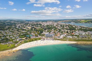 An aerial view of a coastal town with a beach, residential areas, and a marina. - Sea views with balcony & parking | 8 The Liner (Falmouth)