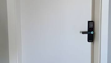 A white door with a modern electronic lock.
