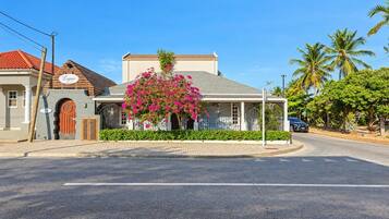 A building with a sign reading 'Lagoon' and a pink flowering tree in front.