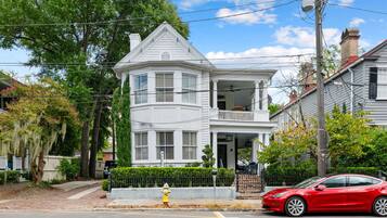 A two-story house with a balcony and a garage.