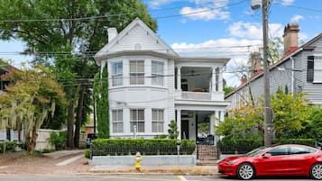 A two-story house with a balcony and a garage.